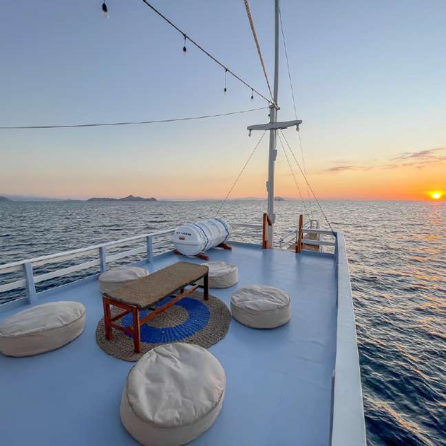 Open-air seating area on the New Pandawa boat overlooking Komodo waters